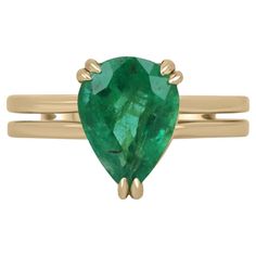 A stunning solitaire emerald right-hand/engagement ring. This edgy piece showcases a distinctive pear-cut emerald from the origin of Zambia. The gemstone showcases a remarkable medium-dark green color, with a subtle yellowish-green hue. Very good luster and clarity are also some of the emerald's best assets. Set in a secure double-prong claw setting, with a split shank design. Crafted and handset in 18K yellow gold. Setting Style: Double Prong Setting Material: 18K Yellow Gold Setting Weight: 5. Yellowish Green, Claw Setting, Yellow Gold Setting, Split Shank, Semi Transparent, Zambia, Pear Cut, Solitaire Ring, Ring Verlobung