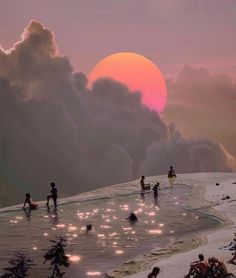 many people are sitting on the beach and swimming in the water as the sun sets