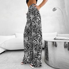 Style: leisure Pattern type: black and white stripes Details: high waisted Hem shape: loose Length: long Fit Type: Regular Fit Elasticity: no Material: Fabric Composition: 100% Cotton Care Instructions: Machine wash or professional dry clean Our Wide Leg Stripe Trousers are tailored for modern style. Crafted from black and white stripes to a high-waisted fit, these trousers exude a relaxed yet sophisticated look. Enjoy the lightweight material that ensures comfort with a long-leg silhouette. Striped Baggy Wide Leg Bottoms, Baggy Striped Wide Leg Bottoms, Black High-waisted Bottoms With Vertical Stripes, Striped Baggy Wide-leg Pants, Black Wide-leg Pants With Vertical Stripes, Spring Wide Leg Zebra Print Pants, Summer Zebra Print Wide Leg Bottoms, Casual Wide Leg Bottoms With Zebra Print, Casual Zebra Print Bottoms For Summer