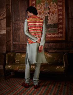 Editor's Note Featuring a bandi framed in festive multi colour design ornated with embroidery, styled with a serene sage kurta and churidaar. Fabric: Bundi: raw silk, kurta and churidar: chanderi Color: Sage, multicolor Components: Kurta, bundi and churidar Occasion: Wedding guest and festive Disclaimer: Product color may slightly vary due to photographic lighting sources or your monitor setting. Care: Dry Clean Only About the Designer Kalista is a luxury fashion label that specializes in design Raw Silk Kurta, Blouse Yoke, Personal Shopping Service, Silk Kurta, Colour Design, Modern Embroidery, Churidar, Kurta Set, Photographic Lighting