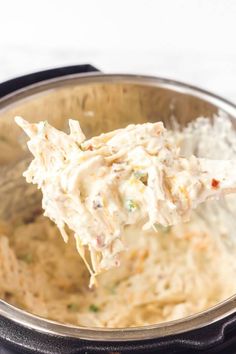 a spoon full of chicken salad in an instant pot