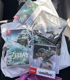 nintendo wii games are sitting on the back seat of a car, with plastic bags around them