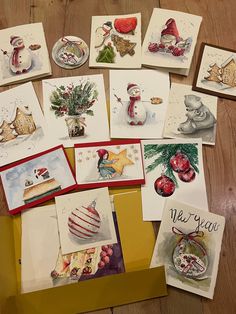 many christmas cards are laid out on the floor