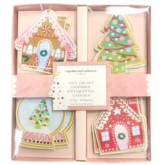 four christmas cookies in a pink box with the words cut - to - eat and decorate them