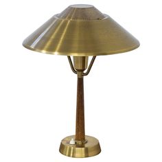 an antique brass table lamp on a white background