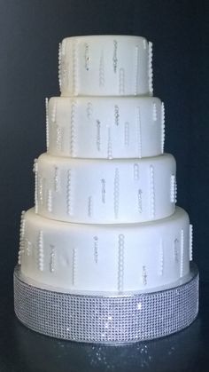 a three tiered white cake sitting on top of a table