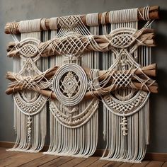 a wall hanging made out of rope and wood sticks