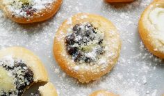 an assortment of pastries with powdered sugar on them