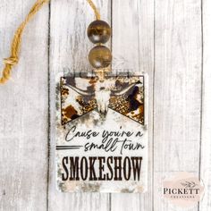 a sign hanging from the side of a wooden wall with an arrow and bow tie on it