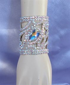 a ring with blue and white stones on it sitting on top of a mannequin