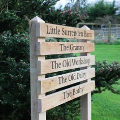 a wooden sign that is in the grass