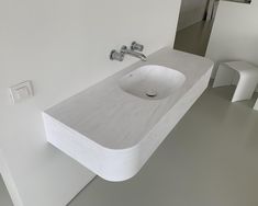 a bathroom sink sitting on top of a white counter