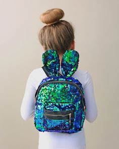 "Carrying your belongings doesn't have to be boring, it can actually be magical. This bunny-eared backpack is great to take a few things on the go. 10\" x 15\" x 6\" Zip closure Spot clean" Glitter Pants, Silver Leggings, Bunny Backpack, Sequin Mask, Sequin Leggings, Sequin Backpack, Twirly Dress, Bunny Bags, Metallic Shorts