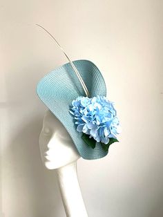 Light blue Hydrangea Hat Light blue Hydrangea Hat will be an amazing accessory to compliment your outfit. The colours can easily pick the colours you would be wearing. A light blue saucer disc hat will fit an average head size. It's made from fabric covered metal headband attached to a light blue colour polybraid saucer disc which sits two white/cream colour Feathers and hydrangea flowers to match the hat.  To secure your fascinator there is a comb inside the hat attached to the headband, so the Blue Fascinator, Kentucky Derby Fascinator, Royal Ascot Hats, Wedding Fascinators, Metal Headbands, Royal Ascot, Blue Hydrangea, Fascinator Hats, Wedding Hats