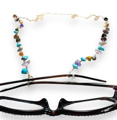 28” long chain with rubber eye glass gaskets to put on the ends of eyeglasses or sunglasses to hold your glasses onto your neck like a necklace. Comes with lobster clasp to transform into a necklace if wanted. Brass, resin and gemstone styles. Designed for convenience and style, this eyeglass holder necklace keeps your glasses close by while adding a chic touch to any outfit. The durable chain ensures secure attachment and the sleek design complements any aesthetic. Keep your glasses easily acce Adjustable Glass Beaded Chain Jewelry, Trendy Glass Jewelry With Lobster Clasp, Trendy Adjustable Glass Jewelry, Glass Necklace With Adjustable Chain As Fashion Accessory, Glass Necklace With Adjustable Chain For Fashion, Adjustable Long Glass Necklace, Eyeglass Holder Necklace, Eyeglass Necklace, Secure Attachment