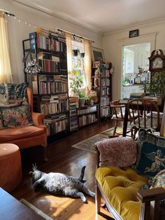 a living room filled with furniture and lots of books