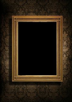 an old fashioned gold frame hanging on the wall in a dark room with damask