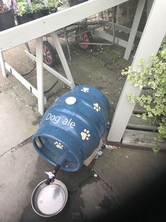 a blue barrel sitting on top of a cement floor