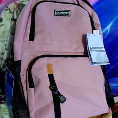 Brand New With Tags Still Intact; Eastsport Backpack. A Netted Water Bottle Holder On Each Side And Lots Of Zippered Po Kets. Light Pink With Black Lining And Lots Of Room For Someone To Add Their Own Creative Flair To. Sporty Pink Backpack For School, Sporty Pink School Backpack, Sporty Backpack For Sports And End Of School Year, Eastsport Backpack, Light Pink Backpack, Water Bottle Holder, Light Backpack, Water Bottle Holders, Pink Backpack