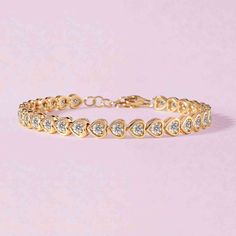 This bezel heart bracelet is a colorful and beautiful twist on a classic tennis bracelet! We love how this bracelet looks layered with other bangles and cuffs. 14k solid gold Average multi gemstone weight is 3.52cts Average pink sapphire weight is 3.0cts Average emerald weight is 2.47cts Heart dimensions: 5 x 4mm Length: 6" + 1" adjustable Anniversary Tennis Bracelet For Valentine's Day, Valentine's Day Anniversary Tennis Bracelet, Valentine's Day Anniversary Jubilee Diamond Bracelet, Elegant Gold Heart-shaped Bangle, Valentine's Day Anniversary Jubilee Tennis Bracelet, Cubic Zirconia Bracelets For Anniversary On Valentine's Day, Fine Jewelry Heart-shaped Bracelets For Anniversary, Luxury Round Bracelets For Valentine's Day, Elegant Heart Bangle Bracelet For Valentine's Day