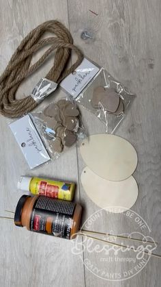 the supplies needed to make this diy necklace are laid out on a wooden floor