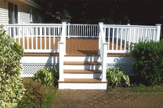 a white deck with steps leading up to it