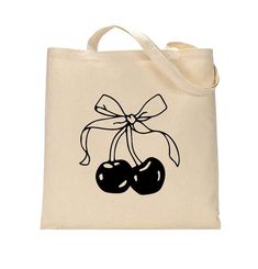 a tote bag with two cherries tied in a bow on the front and side