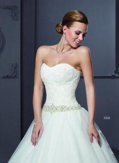 a woman in a wedding dress posing for the camera