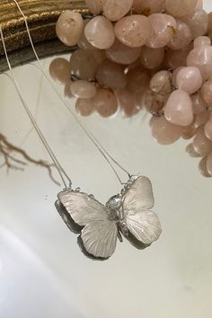 Two of the most beautiful and nurturing creations of Mother Nature have come together in this piece. The butterfly captures the real delicate texture of wings and bursts with your choice of crystal. All crystal clusters are unique and one-of-a-kind. This piece is MADE TO ORDER by our in-house designer and owner, for up to date lead times please check the top of the collection page. If you would like to request priority for a special occasion please email info@stonehartjewelry.com, we can usually Nature-inspired Butterfly Charm Necklaces, Nature-inspired Necklace With Butterfly Charm, Unique Silver Butterfly Necklace, Handmade Silver Butterfly Necklace, Unique Handmade Silver Butterfly Necklace, Nature-inspired Sterling Silver Butterfly Jewelry, Unique Sterling Silver Butterfly Necklace, Unique Silver Butterfly Necklace For Gift, Silver Butterfly Nature-inspired Jewelry