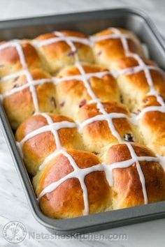 hot cross buns in a pan with white icing