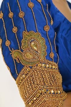 Make a statement with this stunning Blue Bridal Silk Blouse featuring intricate Hand Embroidery work. Festive Designer Embellished Embroidered Top, Semi-stitched Royal Blue Blouse Piece For Wedding, Festive Designer Embroidered Top With Intricate Embroidery, Traditional Embellished Set With Multicolor Embroidery, Designer Embroidered Top For Festive Occasions, Embellished Multicolor Embroidered Fabric For Designer Wear, Multicolor Embellished Embroidered Fabric For Designer Wear, Traditional Embellished Embroidered Top For Festive Occasions, Traditional Festive Embellished Embroidered Top