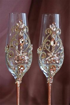 two wine glasses decorated with gold and crystal beads