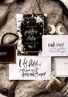 the wedding stationery is laid out on top of each other