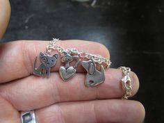 This collection of charms celebrate puppies! You get 3 charms on this bracelet: spot dog, pocket pup, and pooch. Sterling silver charm comes on an adjustable-length bracelet on a sterling silver chain with a sterling lobster clasp. Click here to start your own bracelet: https://www.etsy.com/listing/112427867/starter-charm-bracelet-choose-your-charm You can add charms to this bracelet by purchasing this listing: https://www.etsy.com/listing/103997850/extra-little-charm-for-charm-bracelet Items ar Silver Charm Bracelet For Best Friend, Cute Silver Dangle Charm Bracelet, Sterling Silver Charm Bracelet For Friendship, Sterling Silver Charm Bracelet For Friendship With Lobster Clasp, Sterling Silver Charm Bracelet With Lobster Clasp For Friendship, Silver Charm Bracelet For Best Friend Gift, Silver Charm Bracelet With Polished Finish, Hypoallergenic White Sterling Silver Charm Bracelet, Whimsical Nickel-free Silver Charm Bracelet