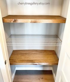 an empty closet with shelves and wire shelving