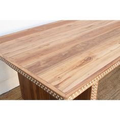 a wooden table sitting on top of a carpeted floor