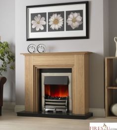 a living room with a fire place and pictures on the wall