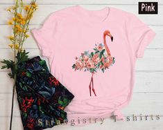 Casual Flamingo Print Tops For Spring, Casual Spring Tops With Flamingo Print, Summer Cotton Tops With Flamingo Print, Cotton Top With Flamingo Print For Summer, Summer Short Sleeve Top With Flamingo Print, Summer Flamingo Print Short Sleeve Tops, Summer Cotton Top With Flamingo Print, Pink Tropical T-shirt For Spring, Short Sleeve Flamingo Print Summer Top