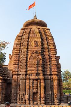 an intricately carved building with a flag on top