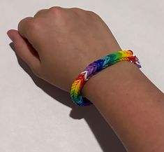 a person's hand with a colorful bracelet on it