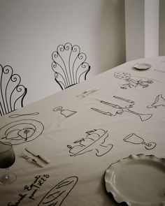 the table is covered with drawings and plates