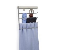 an over - the - door towel rack holds three folded towels and two tie bars