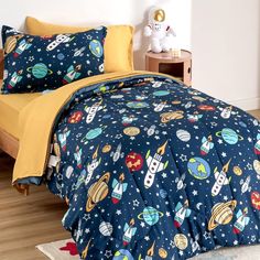 a bed with space themed comforters and pillows