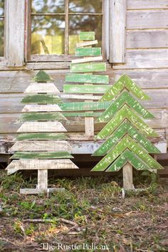 a wooden christmas tree sitting on top of a table next to a sign that says place garden stake set by august grove