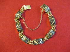 "A Vintage 1960's Damascene Enamel Gold Tone Bracelet. Visit our shop for awesome retro photos, vintage jewelry, sports memorabilia and home decor. Size: 6 1/2\" long Material: Gold Tone/ Damascene/Enamel Condition: Excellent. Year: 1960's Signed: Unsigned Inventory #: 1985" Lead Soldiers, Retro Photos, Retro Photo, Photos Vintage, Personal Checks, Gold Enamel, Classic Toys, Sports Memorabilia, Chain Link Bracelet