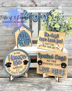 four wooden signs with dogs names on them