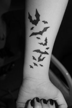 a black and white photo of bats on the wrist