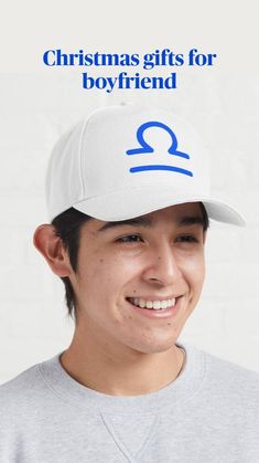 a smiling young man wearing a white hat with blue numbers on the front and sides