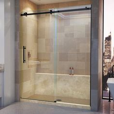 a bathroom scene with focus on the bathtub and shower stall, which has glass doors