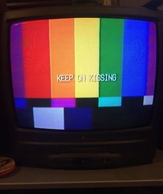 a television with the words keep on kissing written on it